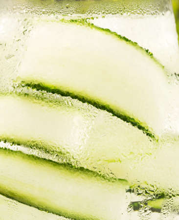 Detox drink with cucumber as backgroundの写真素材
