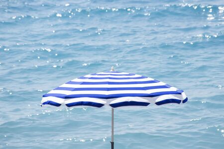 Umbrella over a blue seaの写真素材