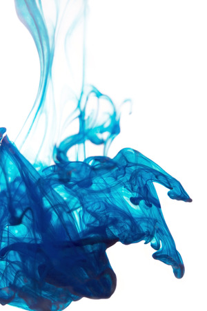 Blue ink dropped into waterの写真素材