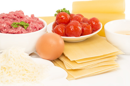 Preparing lasagne - ingredients on white backgroundの写真素材