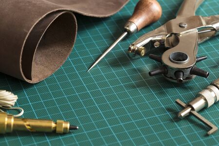 Leather craft tools on a cutting mat