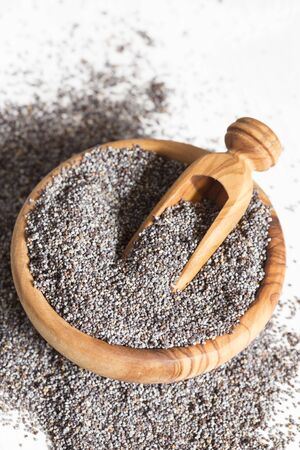 Poppy seeds in a wooden bowlの写真素材
