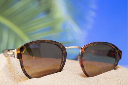 Sunglasses on sandの写真素材