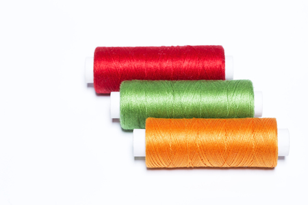Colorful threads on white background