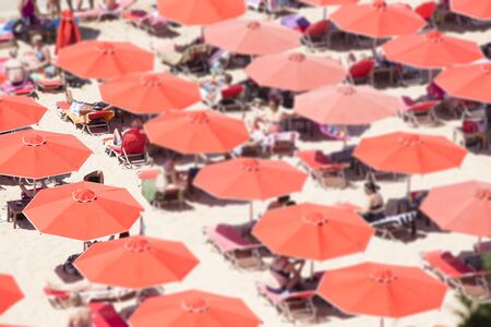 Red umbrellas on a beachの写真素材
