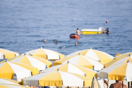 Beach with the yellow umbrellasの写真素材