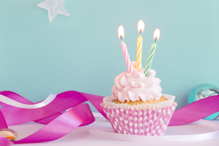 Birthdaw cupcake with the burning candlesの写真素材