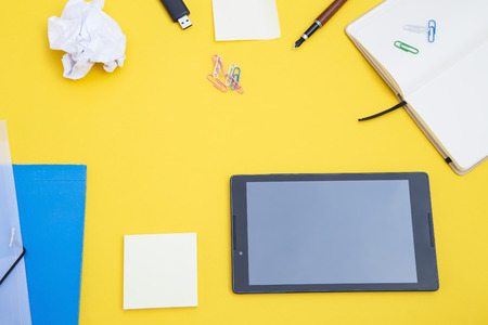 Black tablet with the office suppliesの写真素材