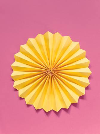 Yellow paper ornament on red backgroundの写真素材