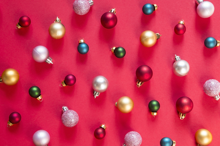 Colorful Christmas baubles pattern with red backgroundの写真素材
