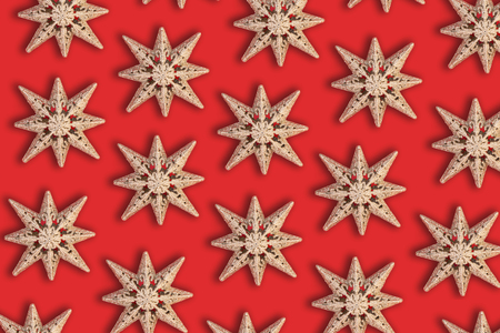 Holiday star pattern on red background - flat lay