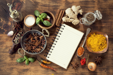 Various herbs and spices with a note bookの写真素材
