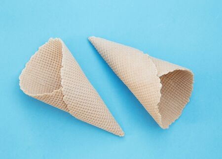 Crisp ice cream cones on blue backgroundの写真素材
