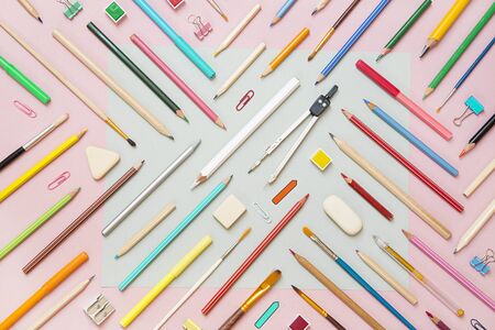 School supplies on pink paper background - top viewの写真素材