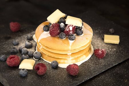 Pancakes with berries, white chocolate and cream