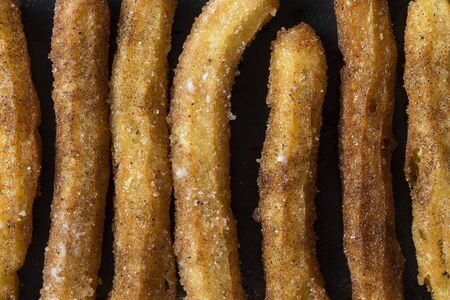 Churro sticks on black backgroundの写真素材