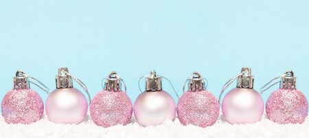 Christmas baubles on white snow