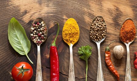 Various herbs and spices on wooden  background - op view