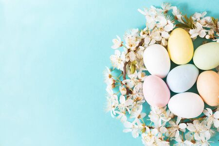 Easter eggs and flowers on blue  background