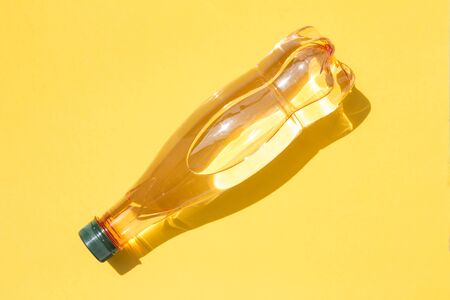 Mineral water bottle on yellow backgroundの写真素材