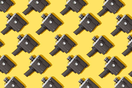 Vintage movie cameras  pattern on yellow backgroundの写真素材