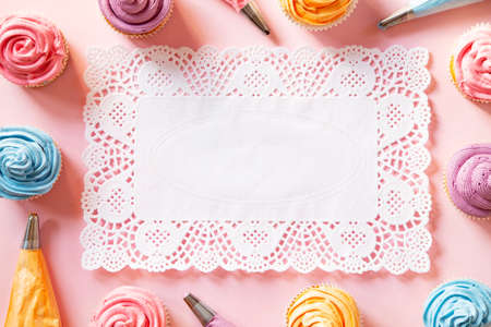 Colorful birthday cupcakes on pink  background