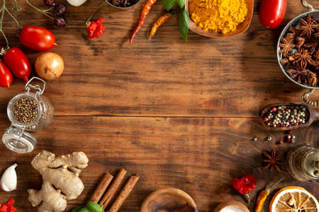 Various herbs and spices on wooden backgroundの写真素材