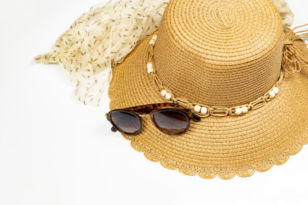 Summer accessory - straw hat, sunglasses and scarf on white backgroundの写真素材