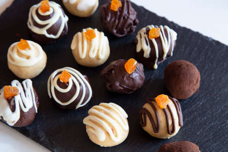 Dark and white chocolate truffles with candied orangeの写真素材