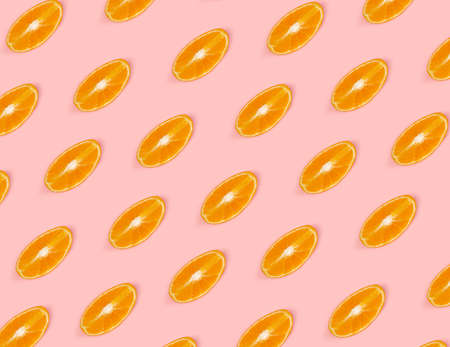 Orange slices pattern on pink background