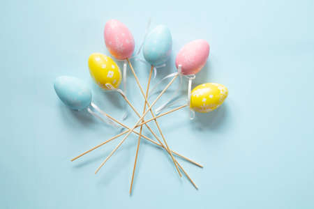 Colorful Easter eggs on blue background with copy spaceの写真素材