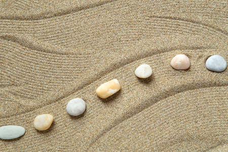 Zen garden with peble stones on brown sand patternの写真素材