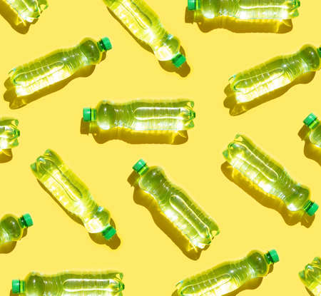 Mineral water bottles pattern on yellow backgroundの写真素材