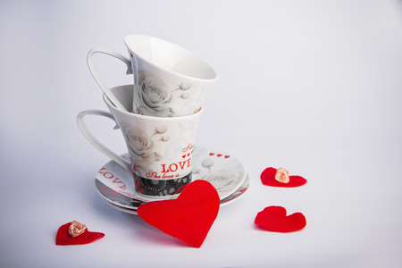 Valentines Day celebration in two: hot beverage cups, white backgroundの写真素材