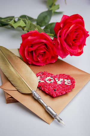 Love letter for valentine, romantic setup with an envelope with sweet words for a loved one, white backgroundの写真素材