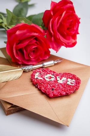 Love letter for valentine, romantic setup with an envelope with sweet words for a loved one, white backgroundの写真素材