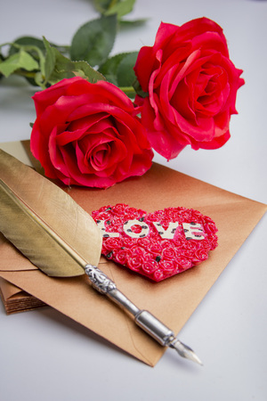 Love letter for valentine, romantic setup with an envelope with sweet words for a loved one, white backgroundの写真素材