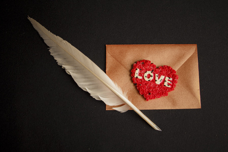 Love letters: quill, envelope and a heart seal for the most romantic present, valentines day concept, black backgroundの写真素材