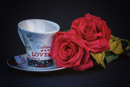 Valentines Day celebration in two: hot beverage cups, black backgroundの写真素材