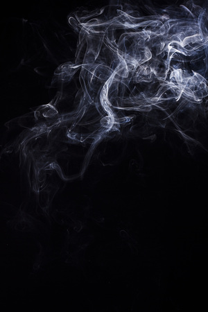 Swirly cloud of smoke on black background, used for design and as various graphic resourceの写真素材