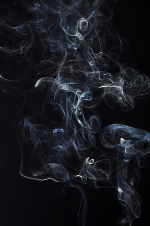 Swirly cloud of smoke on black background, used for design and as various graphic resourceの写真素材