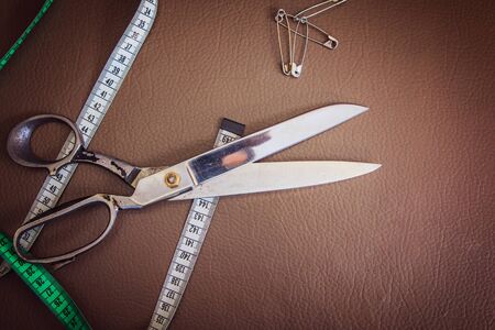 Clothing tools and accessories closeup, scissors, threads and needles