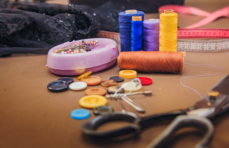 Clothing tools and accessories closeup, scissors, threads and needles
