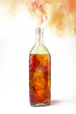 Magic potion releasing cloud of smoke or fumes, green potion in a translucent bottleの写真素材