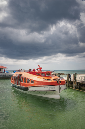 PRINCESS CAYS, FEBRUARY 2015 - Tender boat from a cruise ship docking in the port of Princess Cays island, disembarking passengers and tourists.のeditorial素材