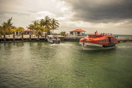 PRINCESS CAYS, FEBRUARY 2015 - Tender boat from a cruise ship docking in the port of Princess Cays island, disembarking passengers and tourists.のeditorial素材