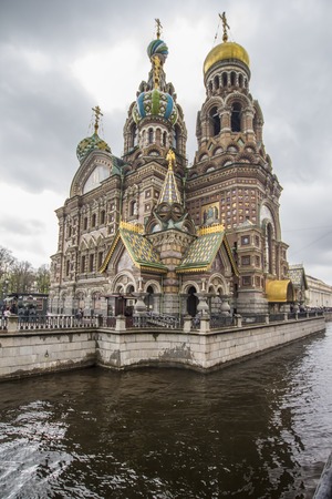 JUNE, 2015: ST. PETERSBURG, RUSSIA - Church of Spilled Blood on a cloudy day, surrounded by visitors and tourists. One of Russias main historic monuments.のeditorial素材