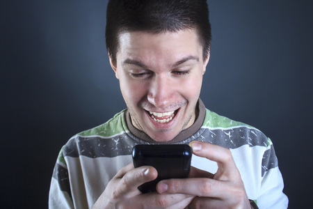 Portrait of a young man addicted to using smart phone or social media, modern social issueの写真素材