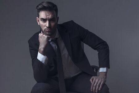 Corproate young man with a suit and tie, studio image of a young business man