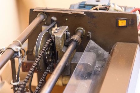 Old paper cutting machine gear inside of a print shopの写真素材